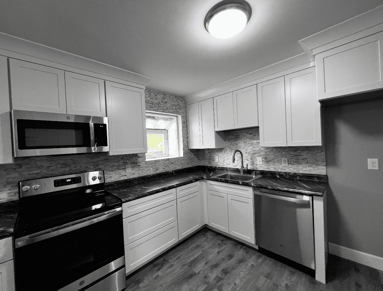 Kitchen renovation before - modern white kitchen with black granite countertops