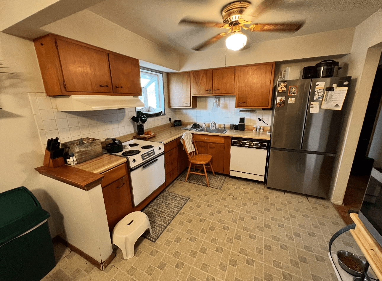 Kitchen renovation after - older kitchen with wood cabinets and white appliances